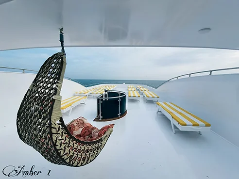 Relaxing on deck of yacht during transformative wellness retreat in Egypt's Red Sea